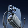 A black retractable car charger with a digital display and multiple cables is shown resting on a blue car interior.