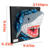 A 2166 piece mosaic building block wall art kit shaped like a shark, featuring blue and white blocks.