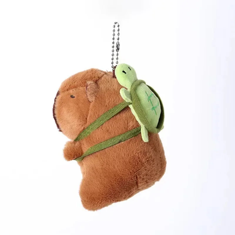 Brown capybara plush toy with a green duck swim ring attached by a chain.