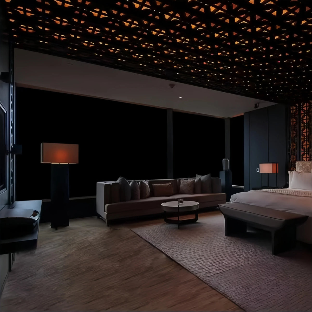 Interior view of a modern room featuring a large window with blackout privacy film and dark decor.