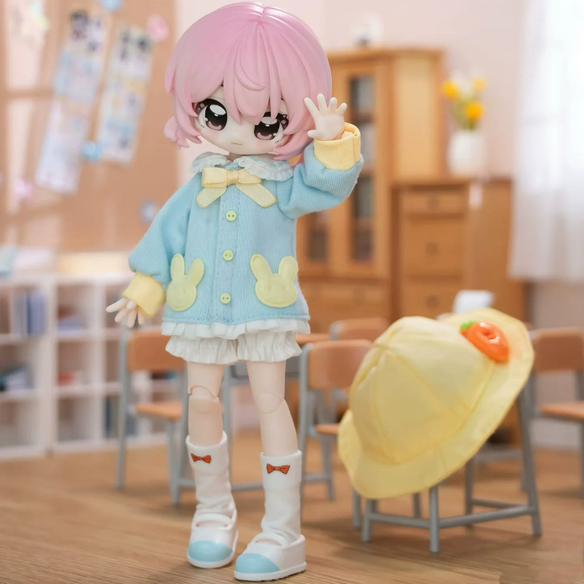 A pink-haired BJD collectible figurine wearing a light blue outfit and white boots, standing in a brightly lit room.
