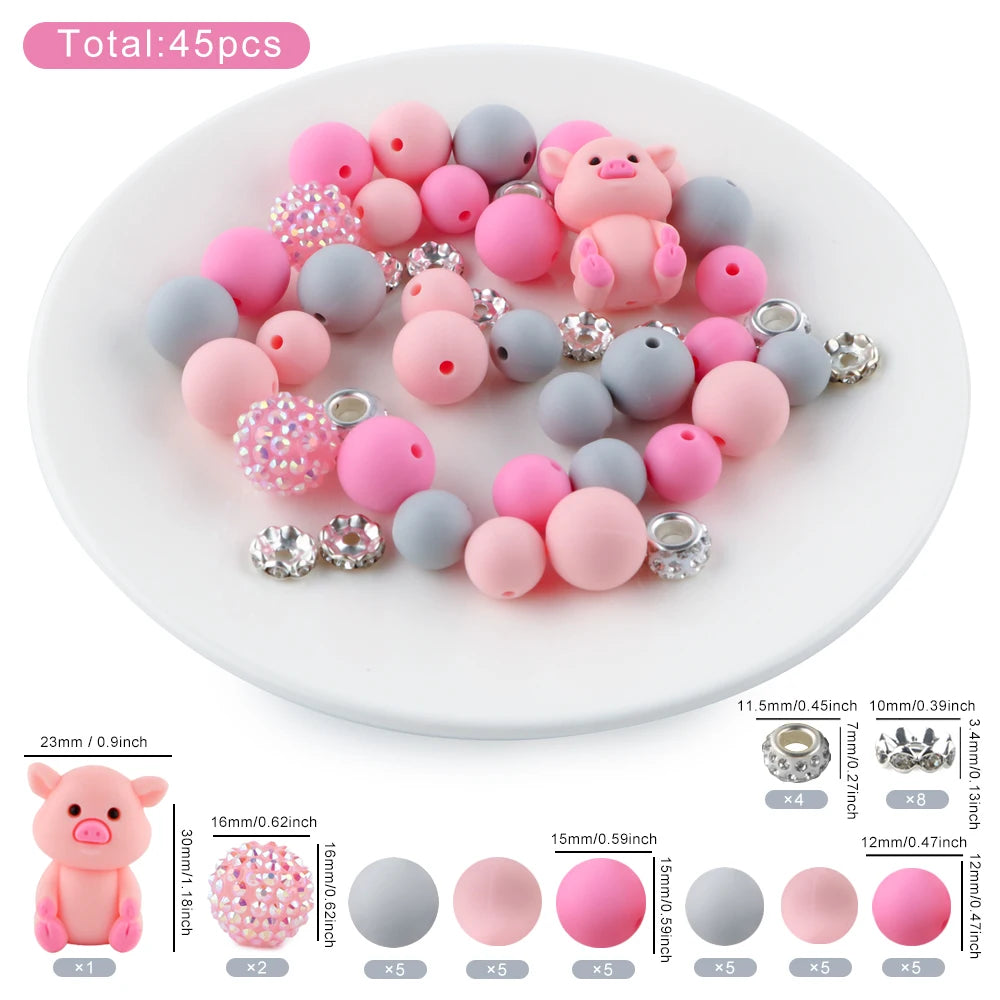 A collection of 45 round silicone beads in pink and gray colors, including a pig shape, for jewelry making.