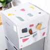 A white refrigerator dust cover with colorful fabric accents and storage pockets is shown on a kitchen counter.