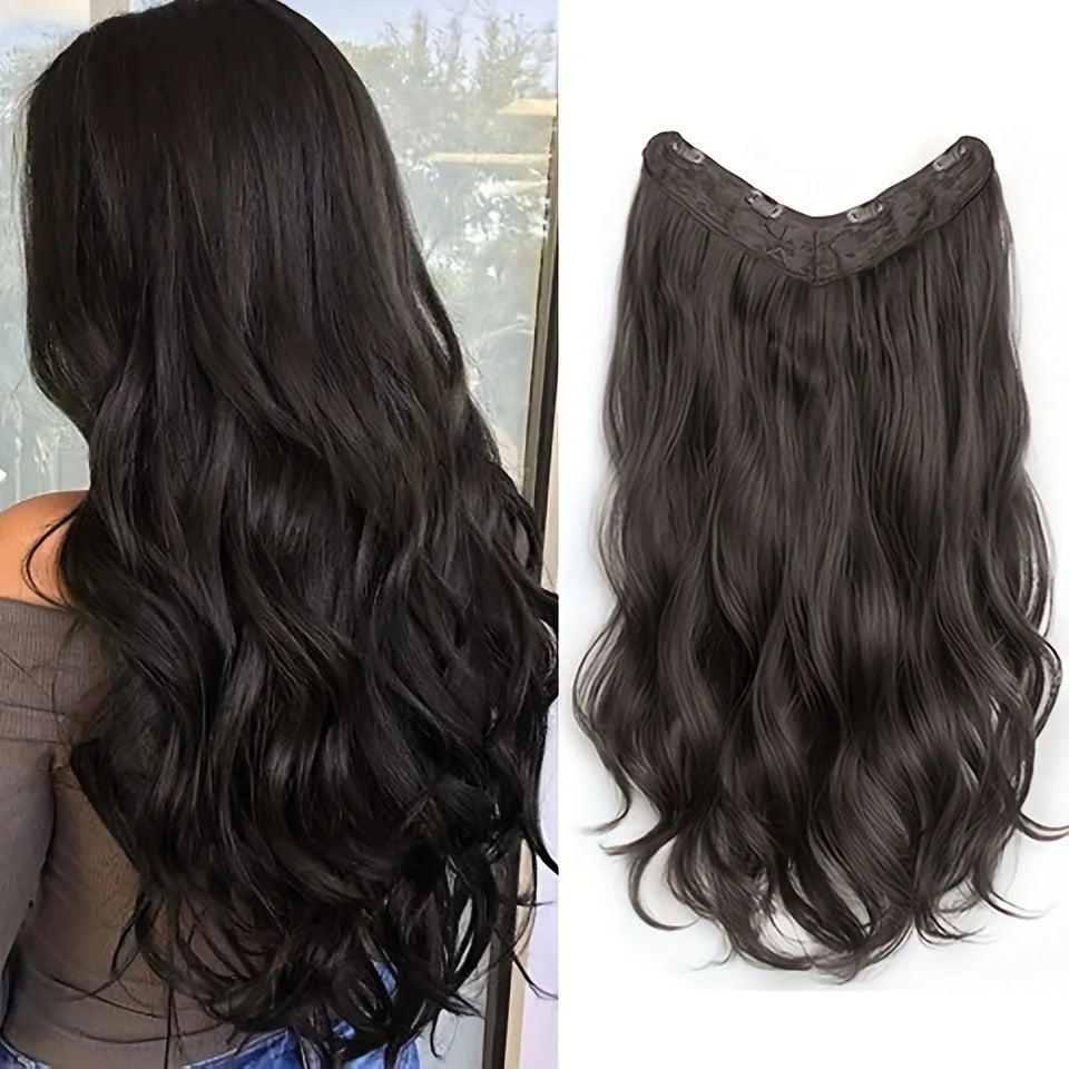 A close-up view of long, dark wavy hair extensions with a decorative clip-in design.