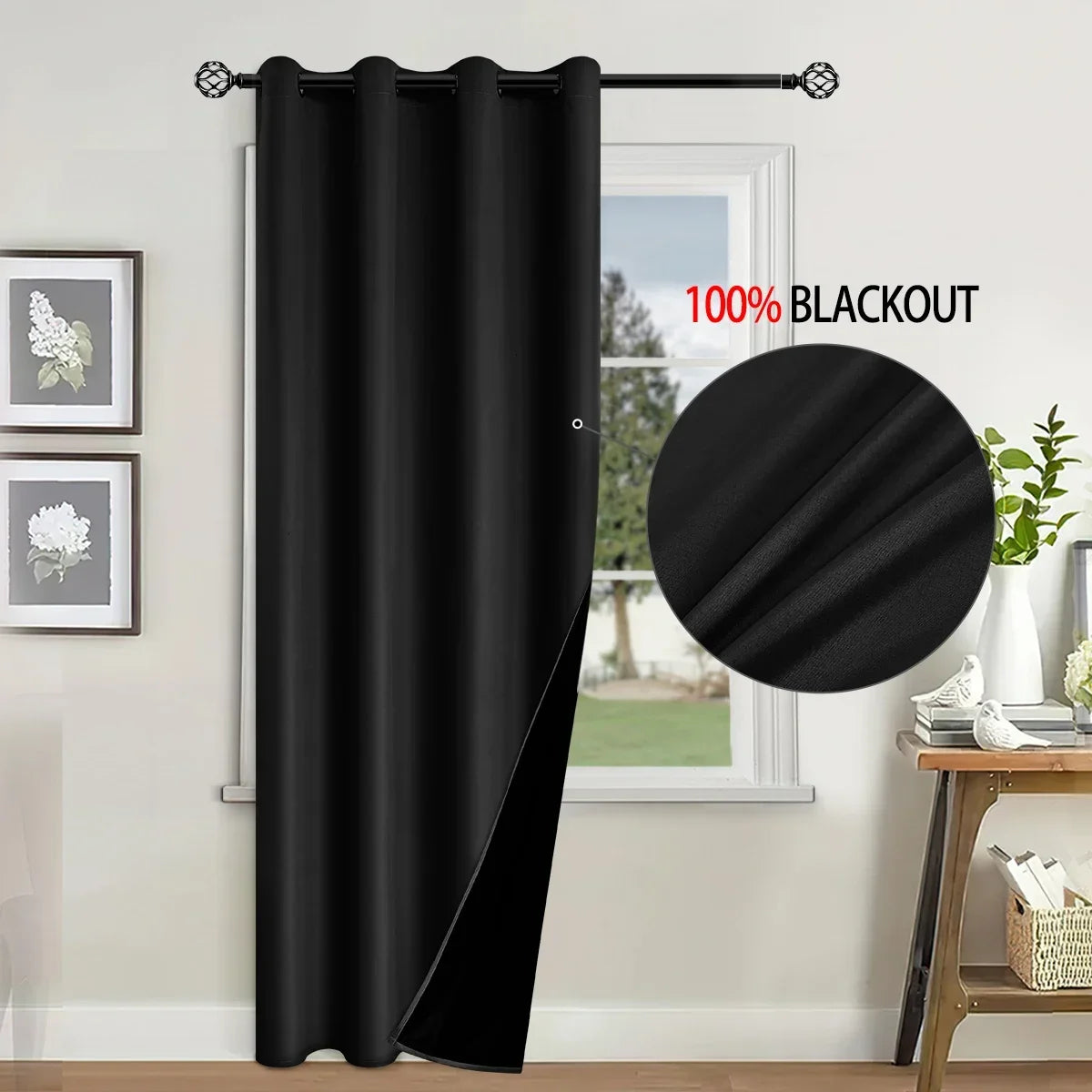 A black blackout curtain hanging in a window, demonstrating its light-blocking properties.