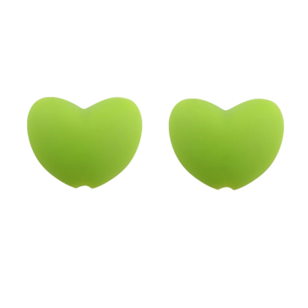 A pair of bright lime green silicone heart beads for DIY jewelry making