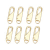 A set of eight gold-colored metal zipper sliders or toggles.