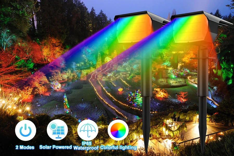 Solar powered waterproof colorful landscape spotlights illuminating a garden at night