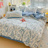A floral duvet cover set featuring blue and white botanical patterns on a bed with natural light.