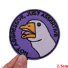 Purple embroidered patch featuring a white duck face with text reading Not Aggressive Just Assertive