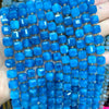 A close-up of blue natural stone square faceted beads strung together for jewelry making.