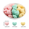 A set of ten silicone heart beads in various pastel colors including quartz pink, mint green, and light yellow.