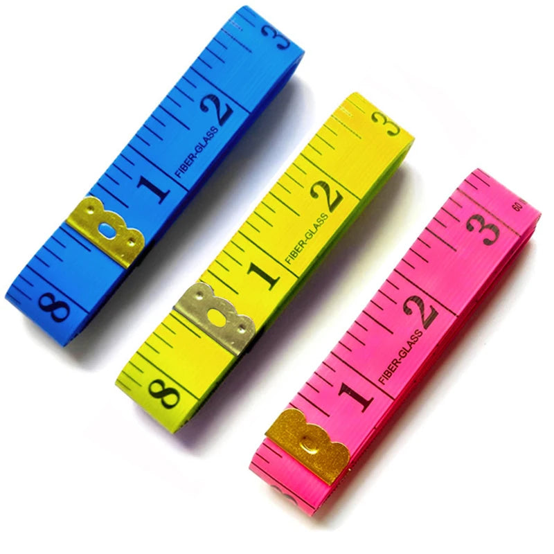 A set of three flexible fiberglass tape measures in blue, yellow, and pink showing inch markings.