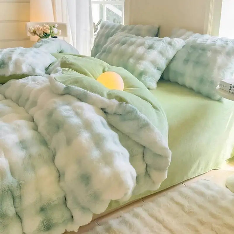 A light green duvet cover featuring a white and pale blue rabbit fleece design on a bed.