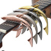 A close-up view of a pro-grade zinc alloy guitar capo with multiple colored metal shapes.