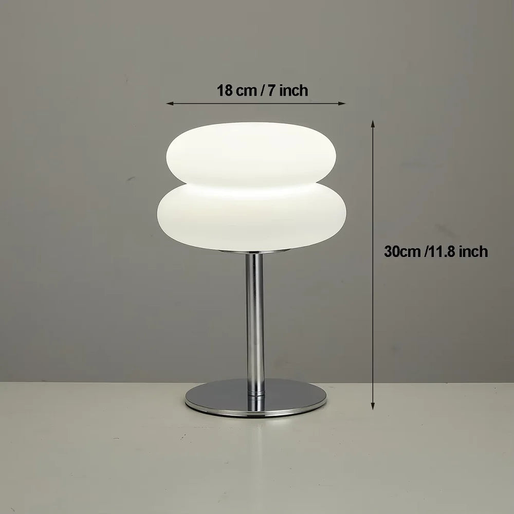 Modern cloud-shaped bedside lamp with a white diffused light and a silver base.