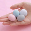 A hand holds four colored anti-slip bedsheet quilt clips, including pink, light blue, and white.