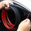 A hand is holding a coiled red and black flexible rubber seal strip used for car door weatherproofing.