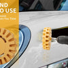 A hand uses a drill adapter to remove a decal from a car surface using a rubber eraser wheel.