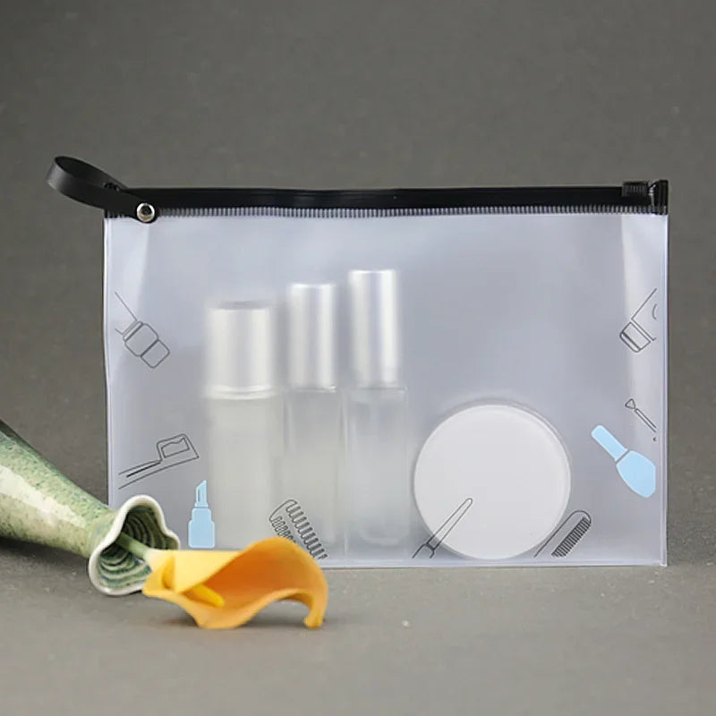 A transparent toiletry bag with a black zipper and hanging hook, containing several glass bottles.