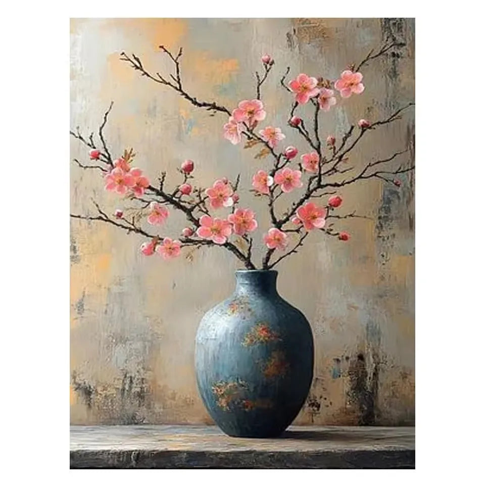 A ceramic vase filled with pink blossoms sits on a wooden surface.