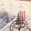 A hanging compression storage bag for winter clothing showing five numbered layers of clothing.