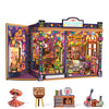 A detailed miniature shop display featuring colorful decor and books, alongside a small wooden book stand.