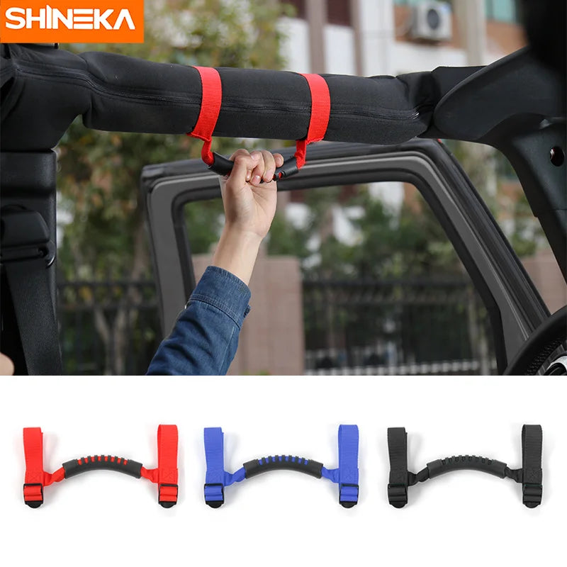 Close-up view of Jeep Wrangler grab handles with pull tabs mounted on an armrest for easy access.