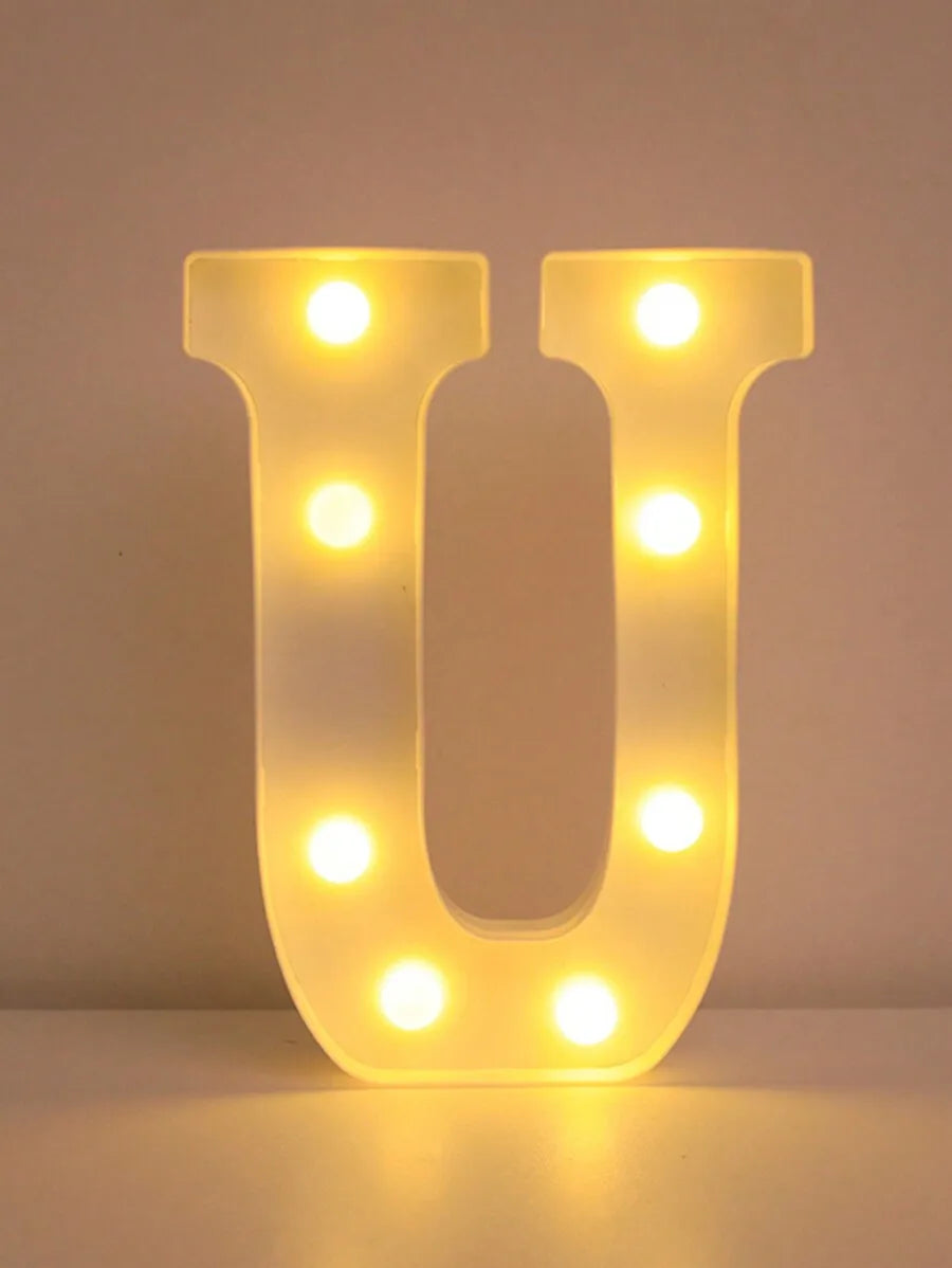 A glowing yellow LED letter night light shaped like the letter U, featuring multiple illuminated dots.