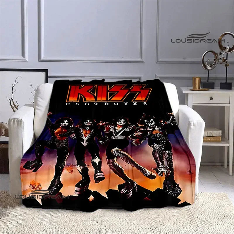 A black flannel throw blanket featuring a graphic print of the KISS band members in dynamic poses.