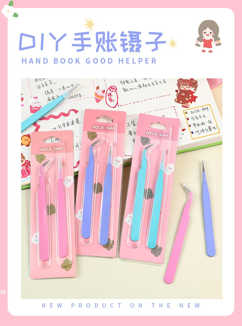 A set of pink and blue macaron color craft tweezers for scrapbooking and journaling displayed in a box.