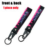 Front and back view of a black lanyard keychain with pink and blue text featuring a stylized anime girl design.