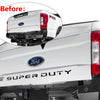 Close-up view of a Ford Super Duty truck tailgate with a decal being applied to the rear light area.