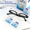 A pair of eyeglasses rests on a white surface next to several individually wrapped lens wipes.