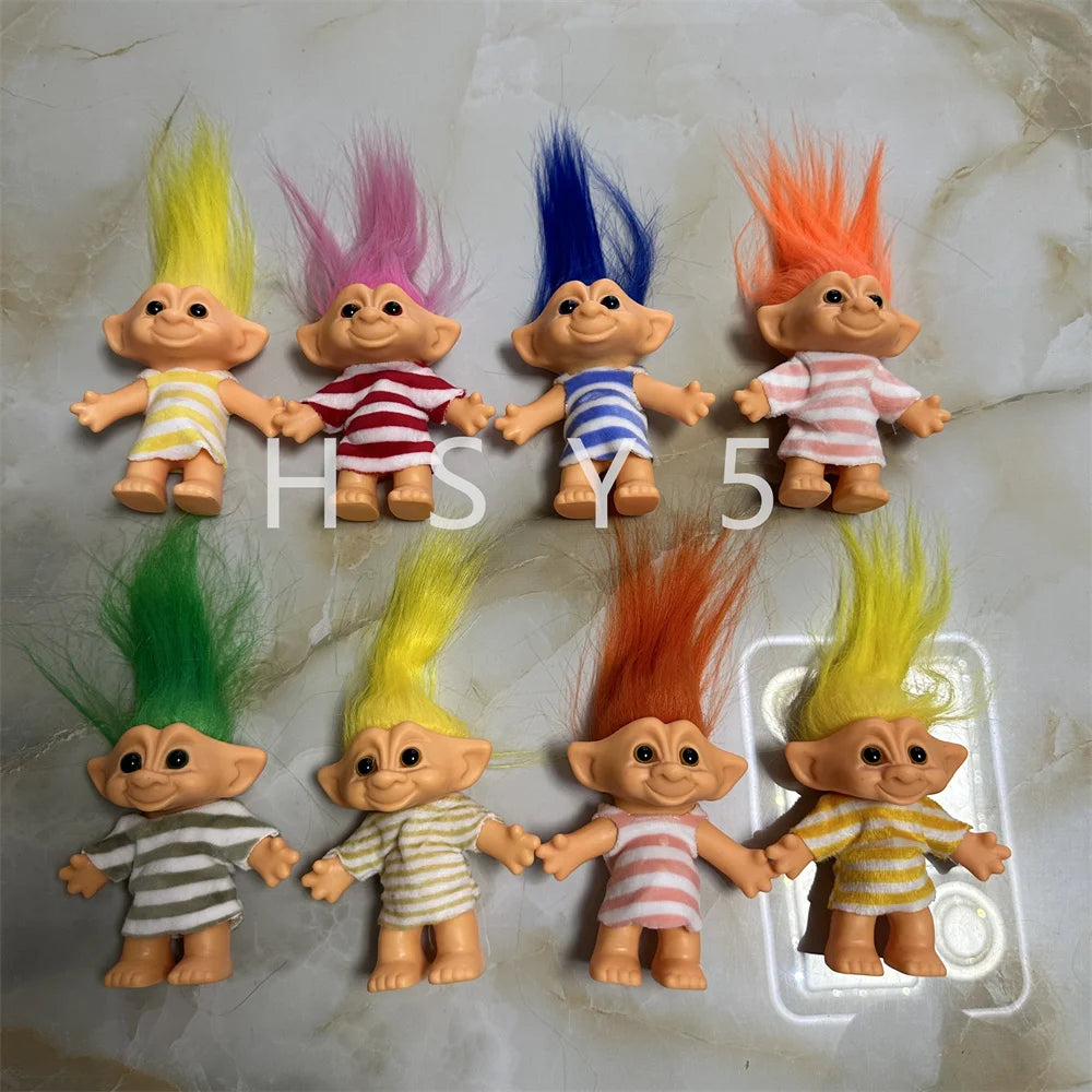 A collection of handcrafted troll doll figurines with brightly colored, spiky hair in yellow, pink, blue, and orange.