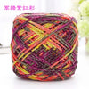 A ball of metallic silk crochet yarn with vibrant pink, yellow, and purple threads.