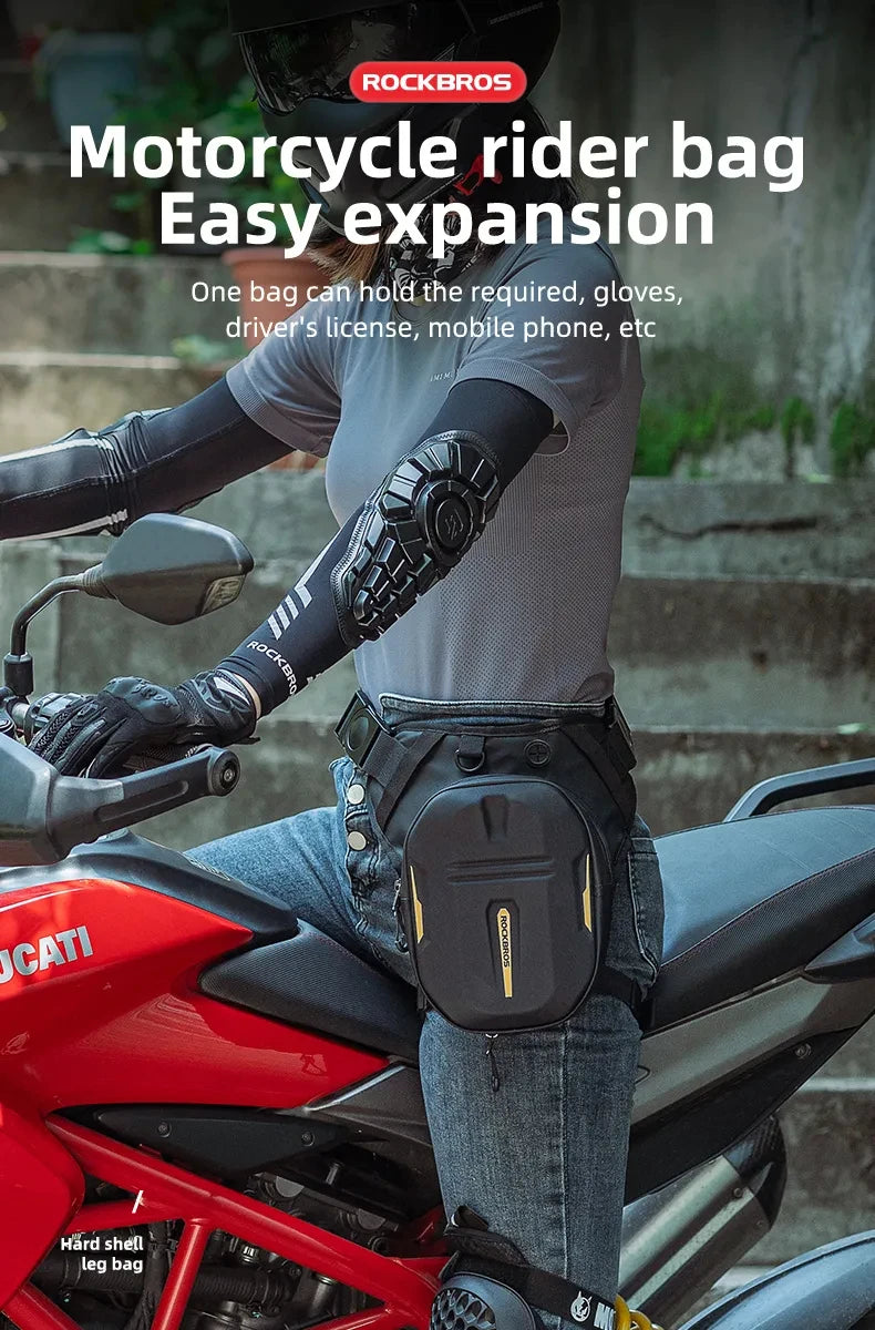A person wearing a grey shirt and black gloves is mounting a red motorcycle with a black rider bag installed.