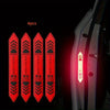 Four reflective warning stickers with caution and danger symbols displayed on a car door panel.