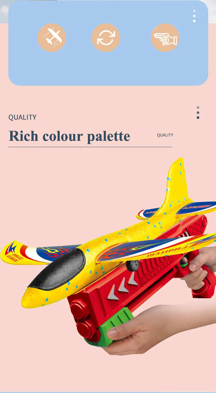 A hand holds a bright yellow and red foam plane launcher toy for kids against a light pink background.