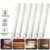 A set of white motion sensor LED night lights shown in various contexts including a bed, storage cabinet, desk, and stair.
