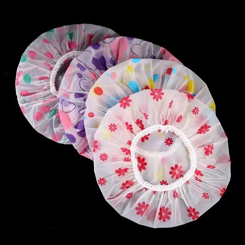 Pink and purple floral waterproof shower caps stacked together
