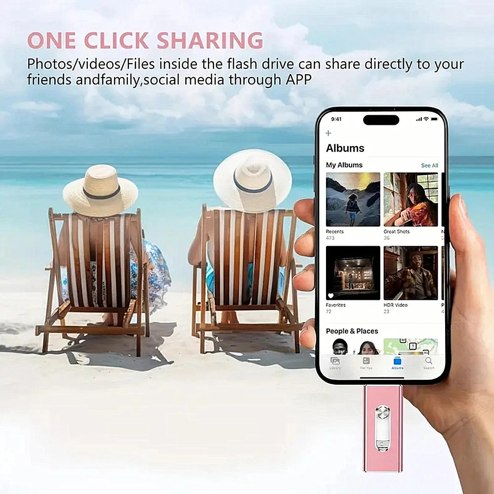 A hand holds an iPhone displaying a photo sharing app interface, with a pink flash drive visible nearby.
