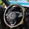 Close-up view of a black steering wheel with a tan faux sheepskin leather cover inside a car interior.