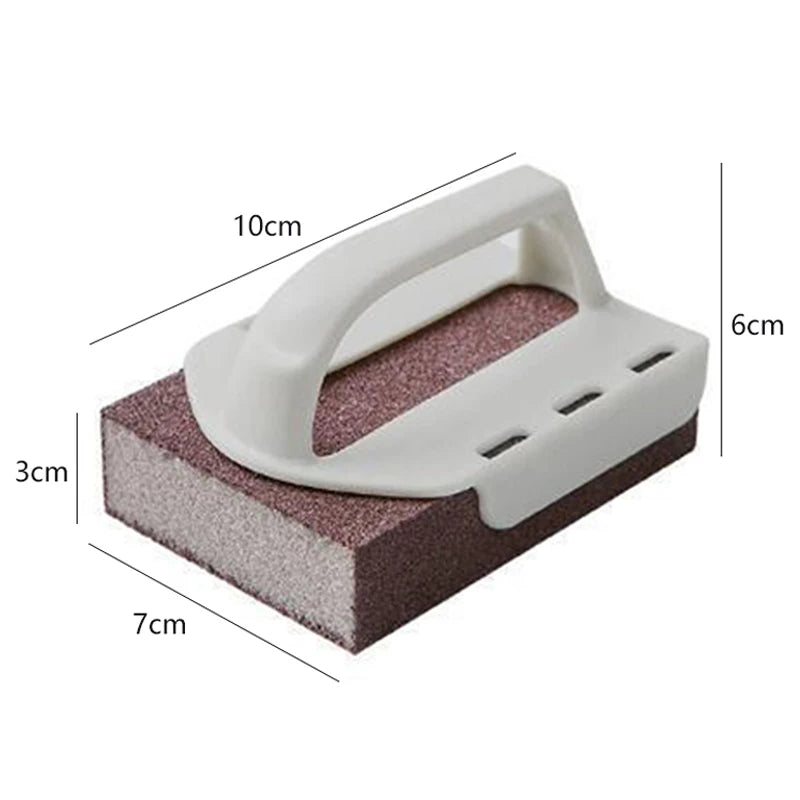 A white heavy-duty emery sponge with a handle is shown resting on a dark pink textured surface.