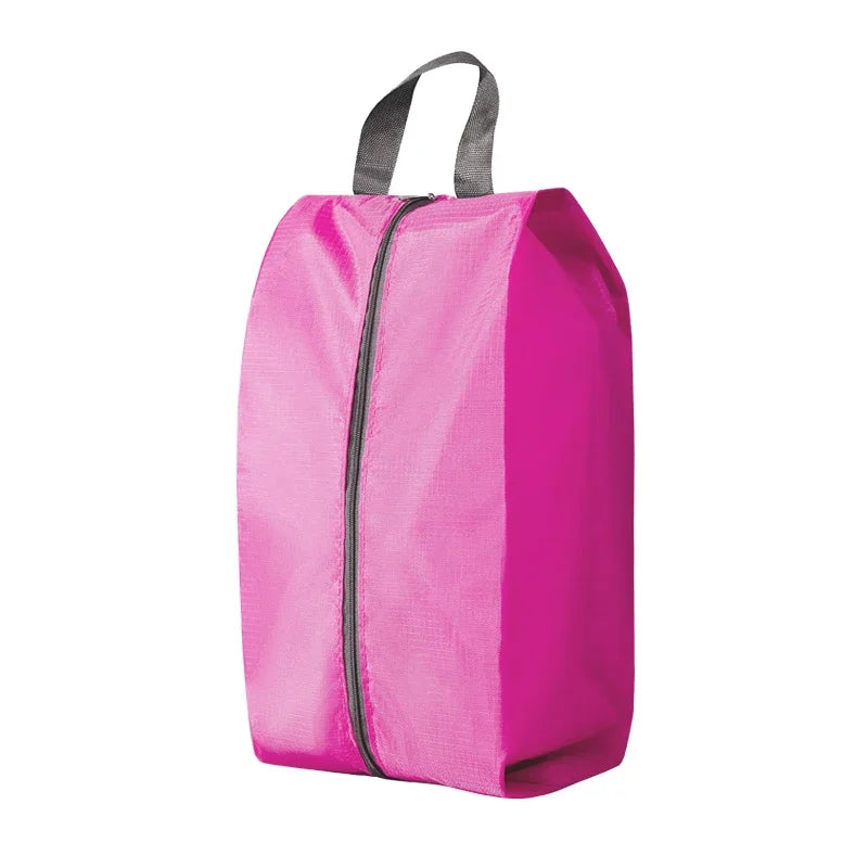 A bright pink foldable nylon shoe storage bag with a black zipper and gray carrying straps.