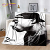 A throw blanket featuring a black and white portrait of Eminem and 2Pac.