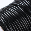 A close-up of black waxed cord rope used for jewelry making and crafting.