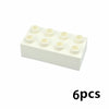 A white tray holding six small, round building blocks.