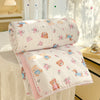 White comforter with a pink and brown panda print featuring small floral patterns and lace trim.