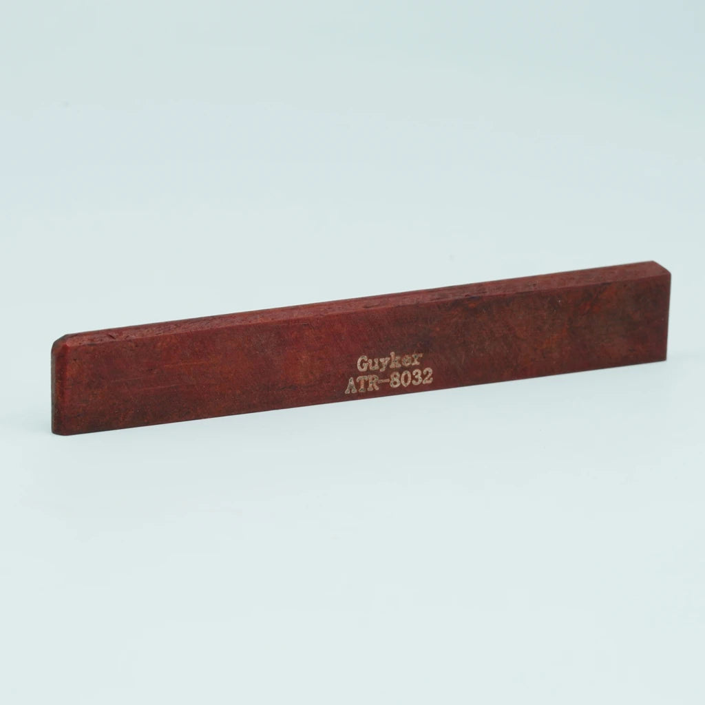 A rectangular piece of reddish-brown wood with the text Guyker ATR-8032 engraved on it.